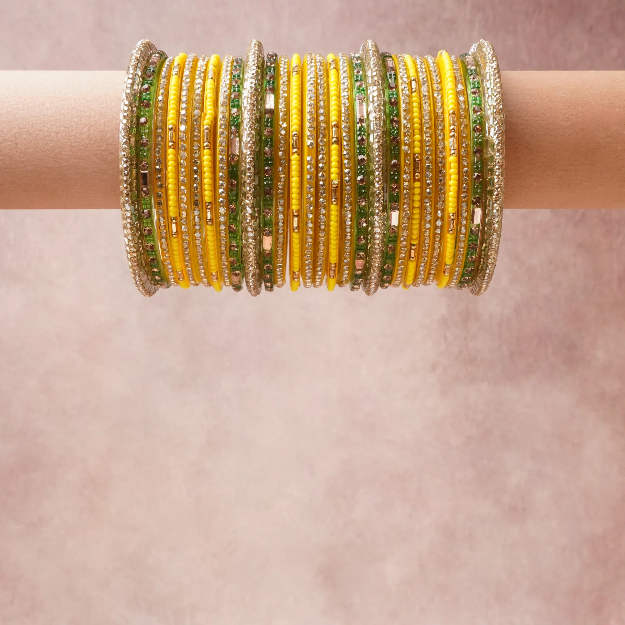 A grounding Vibrant Yellow forms the heart of the set, while touches of  add charm.

A thoughtful composition of Gold-toned Metal, Resin, Glass Seed Beads, Clear Faceted Crystals, designed to feel complete without being heavy.
Each element layers seamlessly, creating a look that is refined, wearable and quietly striking.